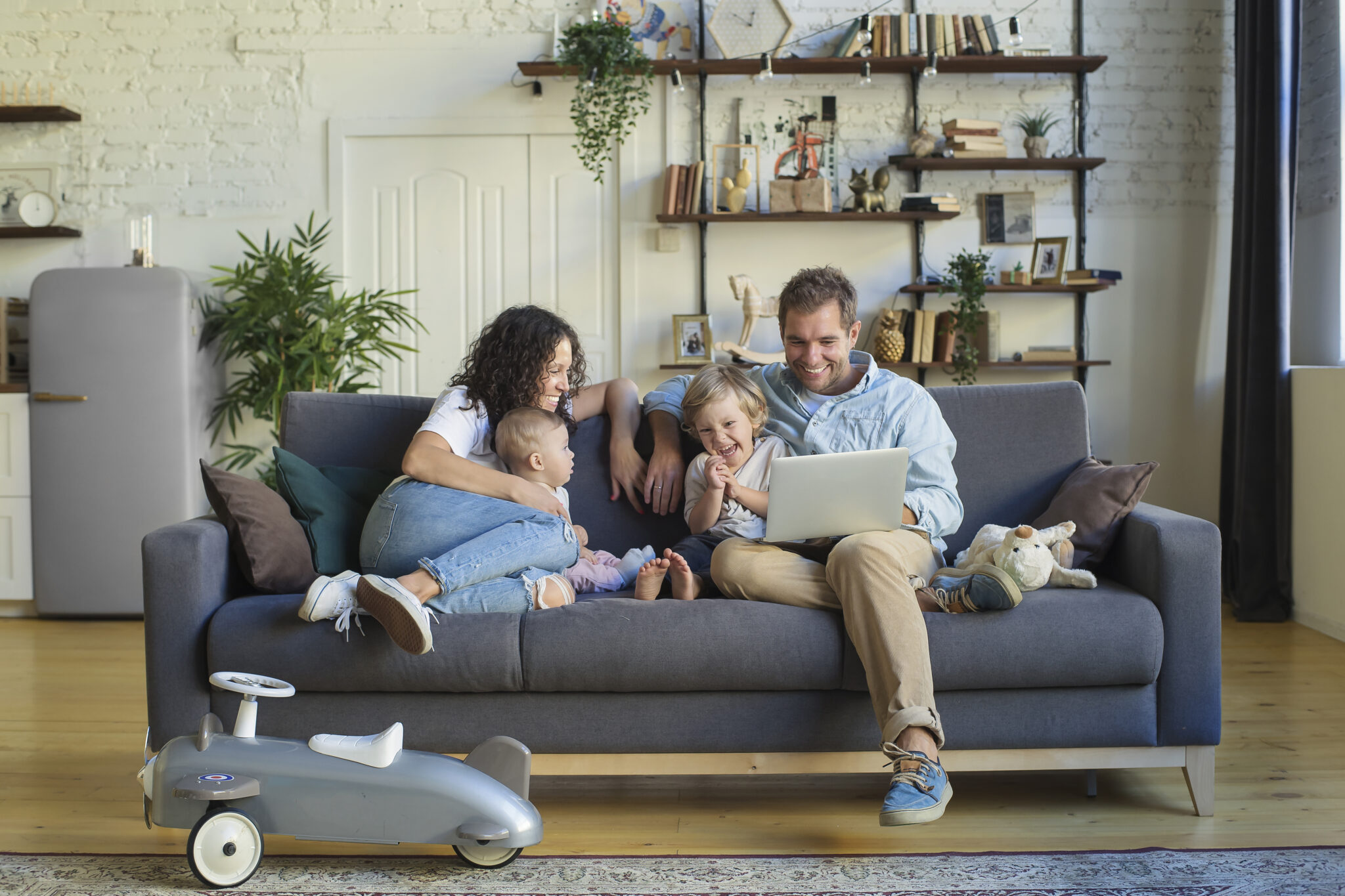 Young beautiful happy family relaxing at home